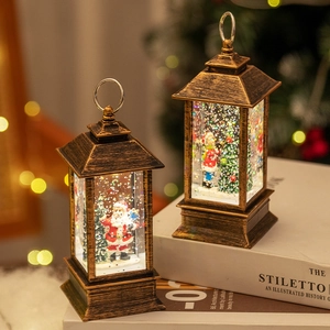 Vintage Christmas lanterns with Santa and snow scene on white books, warm holiday lighting