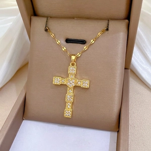 Gold titanium steel necklace with a crystal-encrusted cross and heart pendant on silk