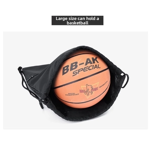 Detailed view of black drawstring gym bag showing large capacity by fitting a basketball