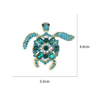 Detailed view of turtle brooch with green crystals and blue rhinestones, size 4.8cm x 5.4cm