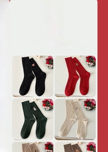 Detail of Christmas crew socks with festive embroidery like Santa and snowmen