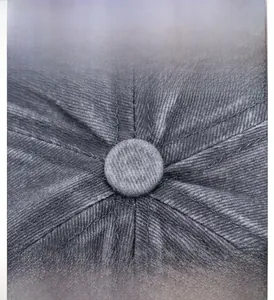 Detail view of stitched grey washed cotton baseball cap with textured top button
