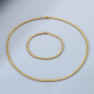 Detail view of gold-plated watchband style chain necklace and bracelet set with lobster clasps