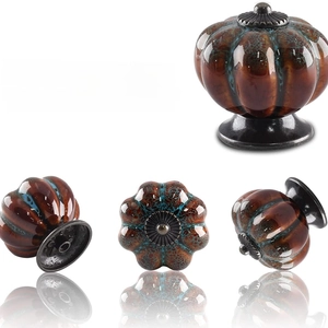 Vintage pumpkin shaped ceramic cabinet knobs with retro glaze and black metal base