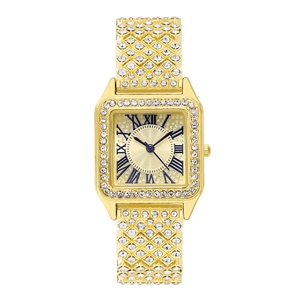 Detailed macro view of the gold square watch face with Roman numerals and crystal dial