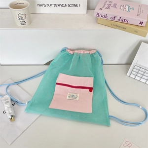 Detail of mesh drawstring backpack with contrast front pocket and macaron color design