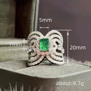 Luxury emerald-cut green gemstone ring with hollow bow design and pavé zircons