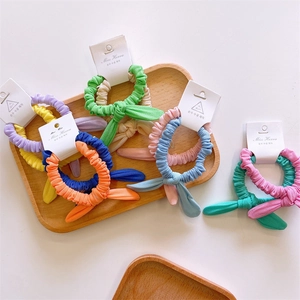 Colorful rabbit ear hair ties in various spring colors displayed on branded cards