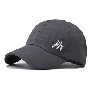 Close-up of white HA embroidery on dark grey cotton twill ponytail baseball cap