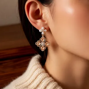 Elegant gold flower drop earrings with white pearls and champagne cubic zirconia stones