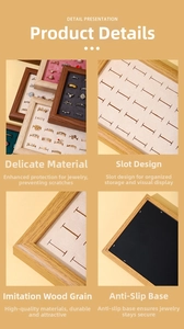 Detailed view of walnut wood grain tray with multiple velvet slots for ring storage