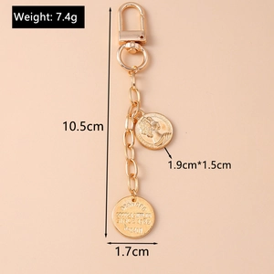 Macro view of gold coin keychain with detailed dimensions and 7.4g weight specifications