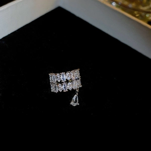 Silver teardrop ear cuff with sparkling zircon stones on a black velvet background