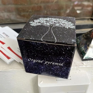 Elegant black Orgone pyramid packaging box featuring a gold Tree of Life design