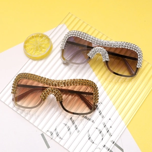 Detail of oversized punk sunglasses with rhinestones in purple and tea gradient lenses