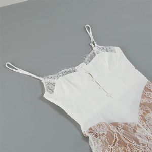 Detail of delicate eyelash lace trim and front button accents on a white midi dress