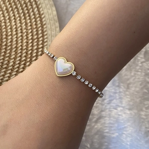 Golden butterfly heart bracelet with white diamonds and mother of pearl on female wrist