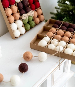 Christmas wool felt ball set with snowflake patterns and twine in a kraft gift box