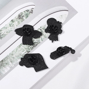 Creative winged dollar enamel pin set with butterfly clutch backing on a white background