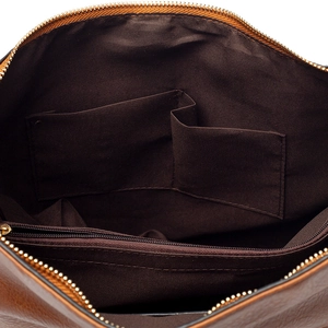 Spacious interior of brown leather tote bag with fabric lining and multiple pockets