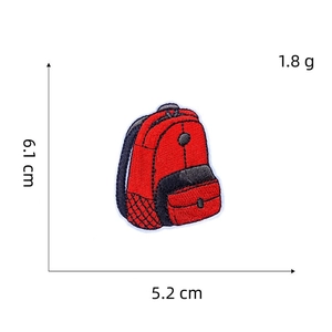 Detail view of red backpack embroidery patch with dimensions 6.1cm x 5.2cm and weight 1.8g