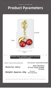 Detail of red crystal cherry keychain showing 8x7cm pendant size and gold alloy clip