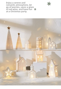 Detail of white ceramic Christmas tree and glowing miniature houses with warm LED lights