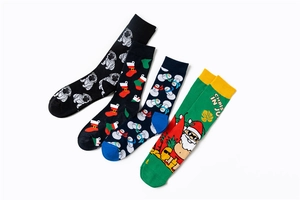 Detail of four knit cotton socks with festive pug, snowman, and Santa Claus holiday patterns