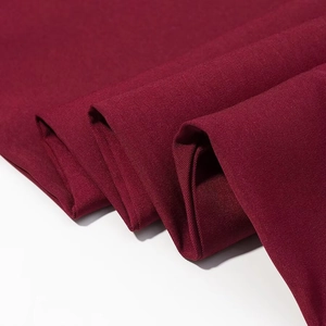 Women loose dark red blazer and trousers set featuring textured twill fabric detail