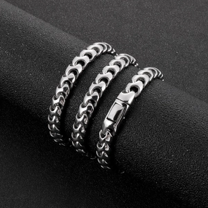 Detailed view of silver stainless steel Cuban chain bracelet with secure box clasp closure