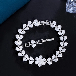 Elegant flower-shaped silver bracelet with pear-cut cubic zirconia on black background