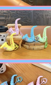 Detail view of colorful saxophone-shaped keychains with cute cartoon patterns