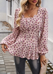Detail of floral puff sleeve blouse with square neckline and cinched waist design