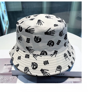 Close-up of white cotton bucket hat featuring dark skull and BOO graphic patterns