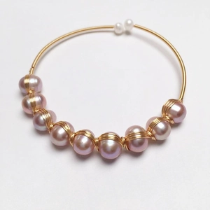 Handmade 14K gold wire wrapped open bangle with elegant purple and white freshwater pearls