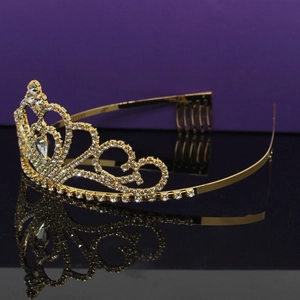 Detail of golden rhinestone crown showing side hair comb structure for secure wedding wear