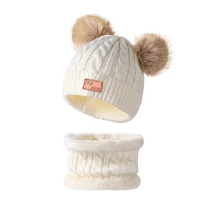 Cozy white cable knit winter hat and scarf set with two brown faux fur pom poms