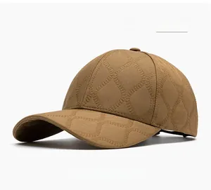 Close-up of khaki baseball cap with embossed geometric texture and six-panel structure