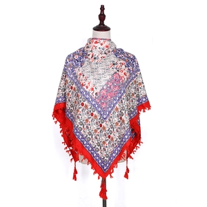 Close-up of Bohemian floral jacquard scarf with detailed red fringe tassels and patterns