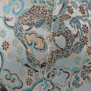 Macro shot of traditional Chinese brocade fabric with golden jacquard pattern on baseball cap