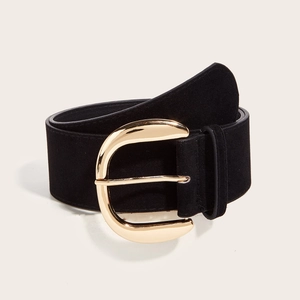 Detail of wide black suede belt with a large polished gold buckle on white background