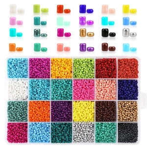 Macro view of 24-compartment storage box with colorful golden and assorted glass seed beads