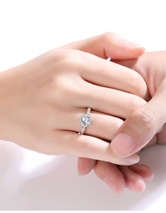 Close-up of elegant S925 silver flower-shaped ring with a sparkling moissanite diamond