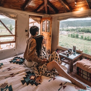 Close-up of bohemian tribal pattern knit blanket on bed in a cozy cabin scenery