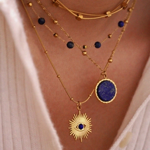 Lapis lazuli layered necklace with 14K gold evil eye pendant on a model