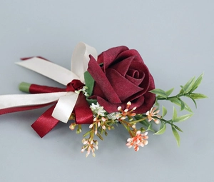 Gros plan détaillé d'une boutonnière faite main avec rose en soie bordeaux et ruban satin