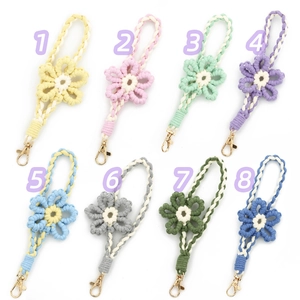 Detail of 8 colorful hand-woven floral lanyards with gold lobster clasps in 2x4 layout