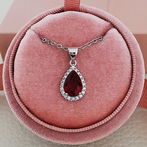 Elegant silver pear-cut ruby necklace with zircon accents in a pink velvet jewelry box