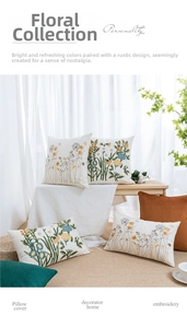 Close-up of daisy embroidery on cotton canvas pillow covers in a rustic setting