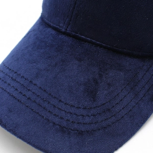 Detailed macro view of navy velvet fabric texture and reinforced stitching on baseball cap